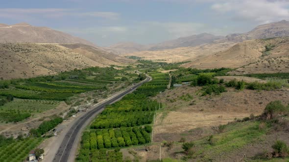 Aerial Drone Shot of Armenia Landscape and Cars on the Road in Summer