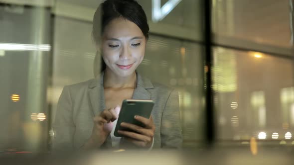 Woman looking at mobile phone in Hong Kong 