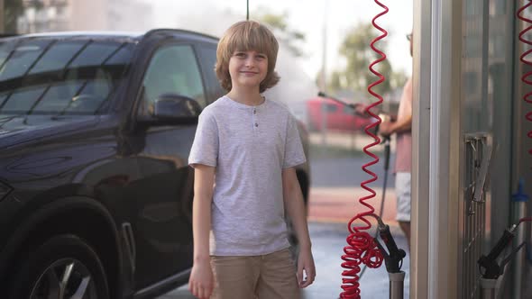 Happy Boy Looking Back at Man Washing Vehicle Turning to Camera Smiling Gesturing Thumbs Up in Slow