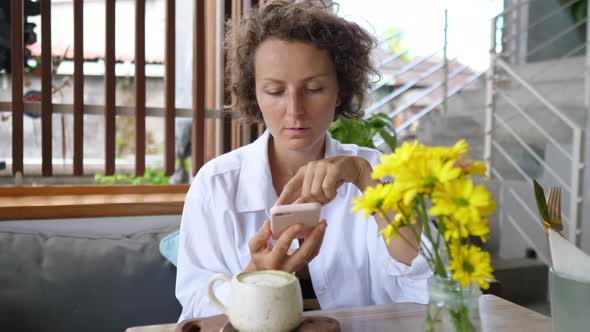 Female Food Blogger Taking a Picture of Her Healthy Matcha Tea Latte