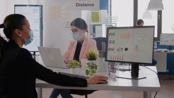 Business Woman Looking at Financial Graphs on Computer Display