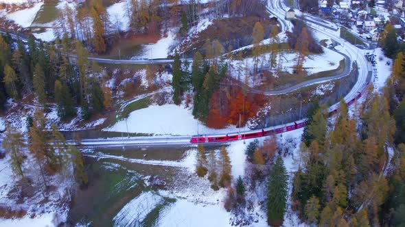 A Train in Switzerland Departing a Village to Transport Tourists and Commuters