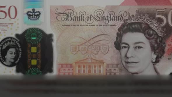 50 English Pound banknotes in cash machine.