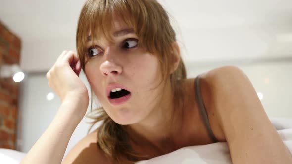 Wondering Woman Lying in Bed Shock Astonished