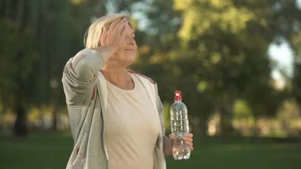 Beautiful Middle Aged Woman Drinking Water After Finishing Her Morning Workout