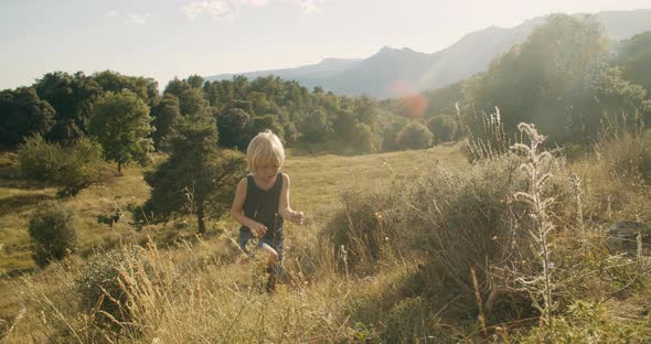 Child climb the mountain with beautiful view on summer vacations