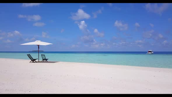 Aerial drone view tourism of tranquil seashore beach wildlife by shallow lagoon with white sandy bac