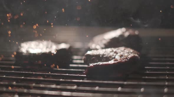 Meat Steak on the Grill. Lots of Fire. Extreme Slow Motion. Cooking Meat Steak on Fire and Coal