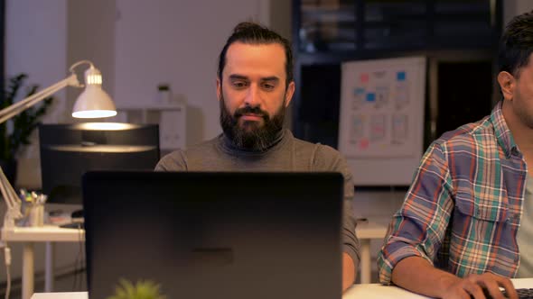 Programmers with Computers Working Late at Office 54