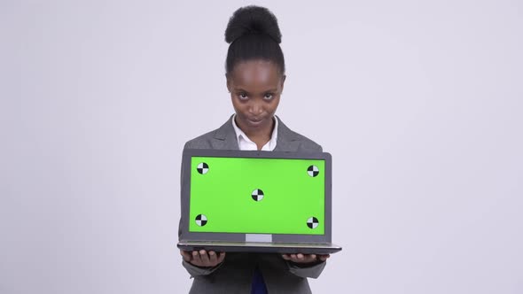 Young Happy African Businesswoman Thinking While Showing Laptop