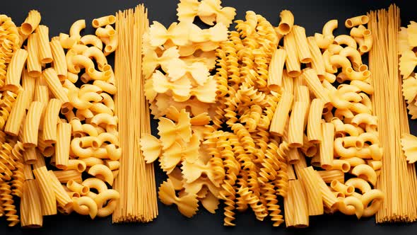 Pile of arranged raw different kinds of pasta. Seamlessly looping animation.