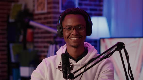 Portrait of African American Podcaster Smiling Confident at Camera While Recording Podcast