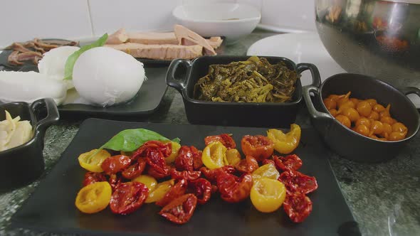 Fresh Ingredients for preparing traditional Italian Pizza on display over a Marble Countertop