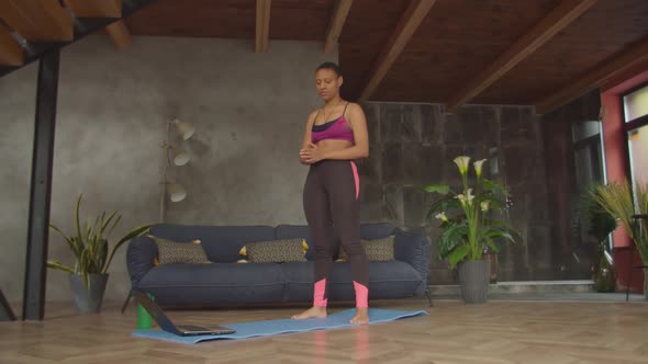Sporty Black Female Doing Squats Exercise Indoors