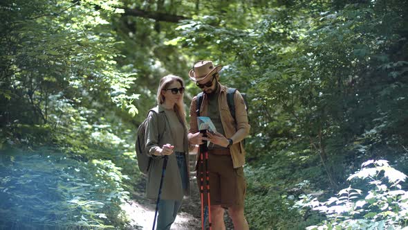 Hiker Practicing Nordic Walking In Forest. Sticks Walking On Jungle Foliage. Nordic Walking Trekking