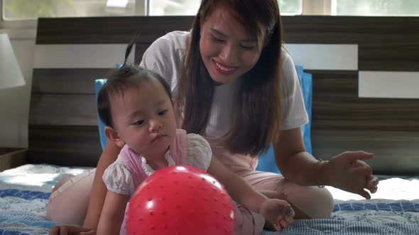 Mother and Child Playing with Ball