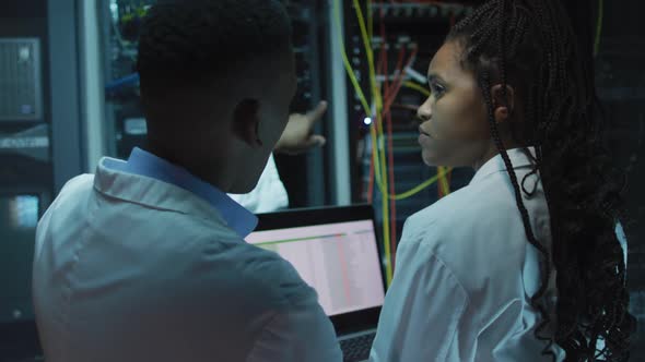 African american computer technicians using tablet working in business server room