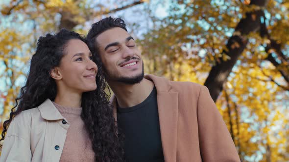 Portrait Hispanic Couple on Date in Autumn Park Attractive Young Woman Huge Handsome Man Outdoors