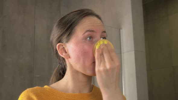 Young woman washes off removes makeup before bedtime skin care routine