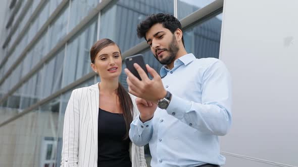 Business People Using Phone Near Office On Street