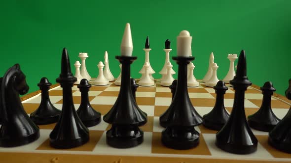 Chess on a chessboard. Shooting against a green background. Chromakey.