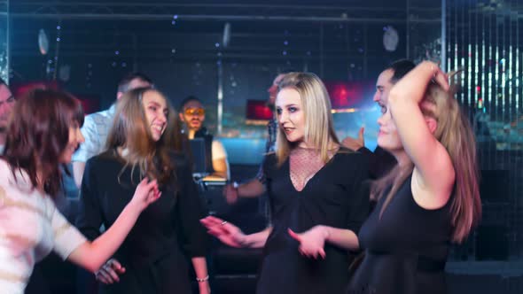 Female Friends are Having Fun and Dancing in a Nightclub