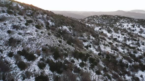 Drone flight around the rugged alpine mountain peaks and valley landscape of Mt, Hermon in the Golan
