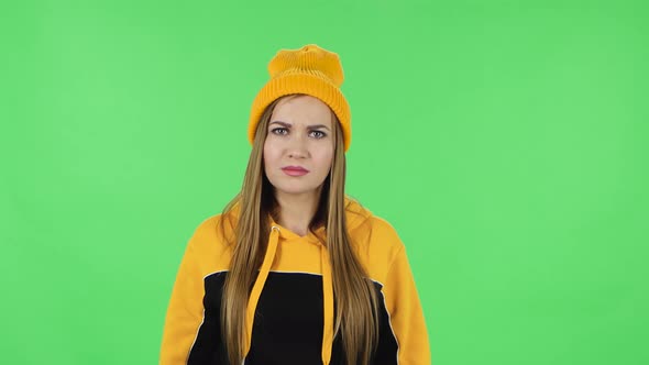 Portrait of Modern Girl in Yellow Hat Is Looking in Surprise at Camera and Is Shocked By What She