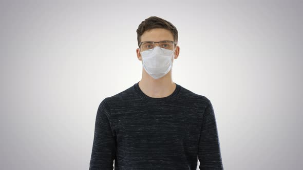 Student in Antiviral Mask Walking on Gradient Background