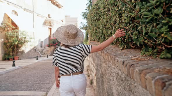 Tourist Woman in Straw Hat Walking on Narrow Ancient Streets