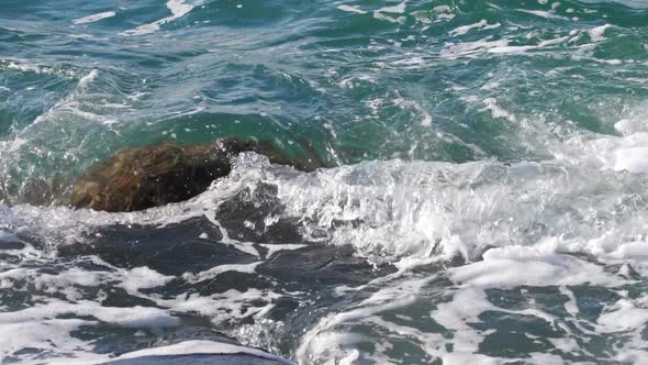 Sea Waves Rolling Over a Rock