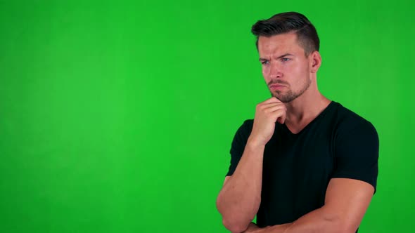 Young Handsome Caucasian Man Thinks About Something - Green Screen - Studio