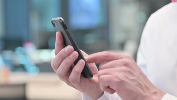 Close up of Middle Aged Arab Man using Smartphone