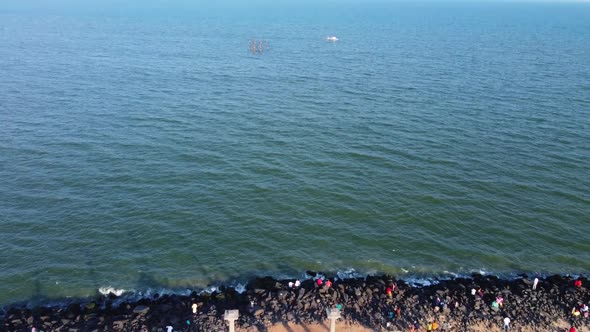Arial view of Mahatma Gandhi Statue and rock beach of Pondicherry. A white structure surrounded by g