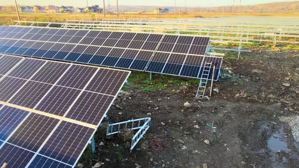 Solar power plant under construction on green field. Assembling of electric panels for clean