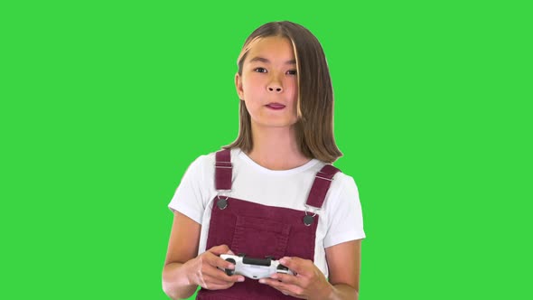 School Girl Playing Video Game on a Green Screen, Chroma Key