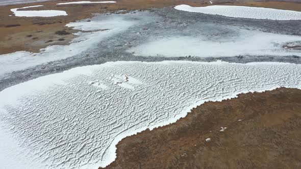 Flying Over Lake in Snow and Fields