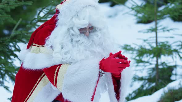 Santa Claus making a snowball