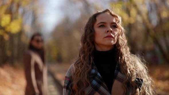 Pretty Woman is Leaving Her Boyfriend Walking Away Scene in Autumn Park in Sunny Weather