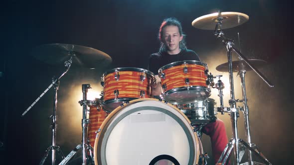 A Man Is Enjoying Playing the Drums in a Studio