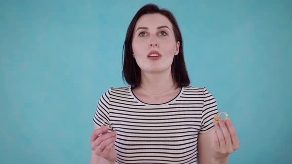 Young Woman with Hearing Impairment Hears Without Hearing Aid on Blue Background