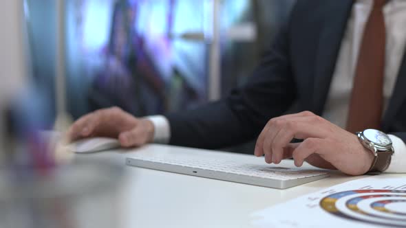 Businessman's hands typing