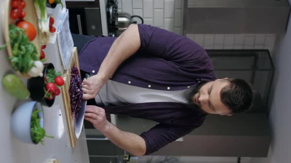 Vertical Shot Man Cooking Healthy in the Kitchen, Slow Motion