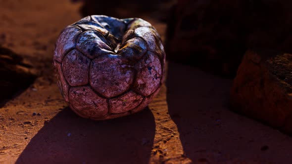 Old Leather Soccer Ball Abandoned on Sand