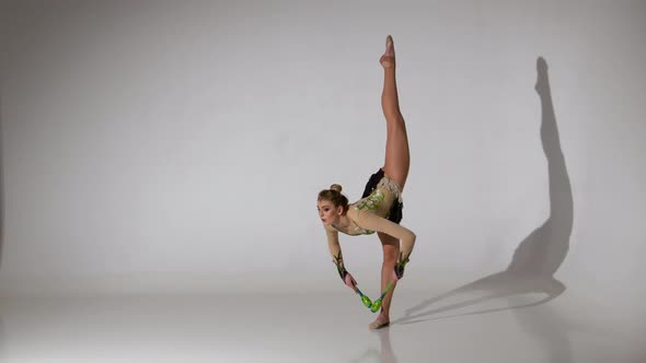 Gymnast Doing Back Flips and Standing on One Leg. White Background