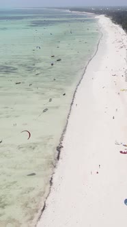 Vertical Video Kitesurfing Near the Shore of Zanzibar Tanzania