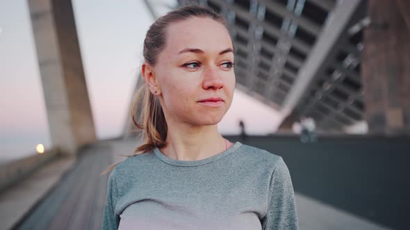 Pensive Beautiful Millennial Woman Posing for Portrait on City Bridge