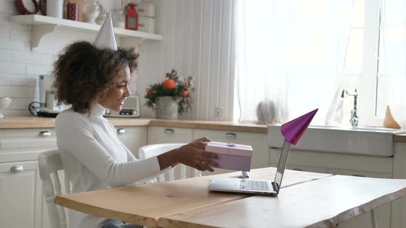African Lady Holds Holiday Decorated Present Box Near Laptop