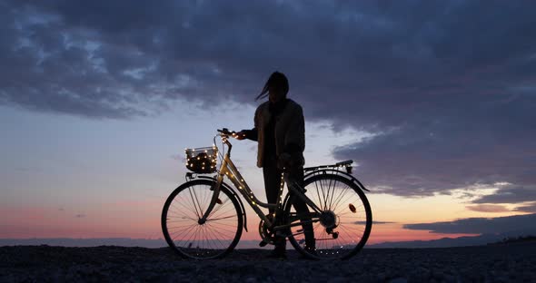 Girl with a Bicycle near the Ocean