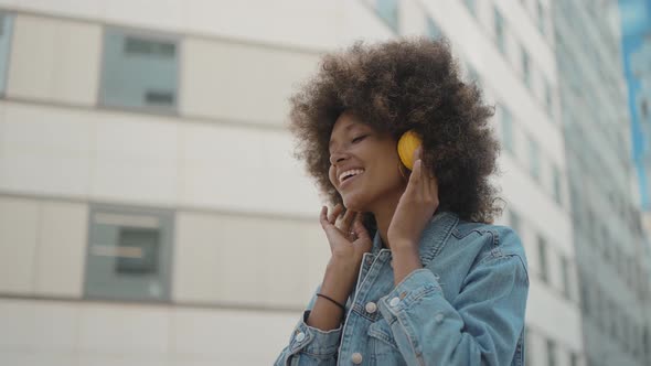 Beautiful young woman with curly hairstyle and fashionable clothes